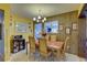 View of the dining room featuring a wood table set for six, wood paneling and yellow walls at 3104 W Powhatan Ave, Tampa, FL 33614