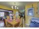 Inviting dining room with wood table set and yellow walls, adjacent to kitchen and living area at 3104 W Powhatan Ave, Tampa, FL 33614