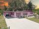 Charming pink one-story home featuring a covered carport and well-maintained landscaping at 3104 W Powhatan Ave, Tampa, FL 33614