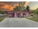 Charming pink one-story home featuring a covered carport and well-maintained landscaping at 3104 W Powhatan Ave, Tampa, FL 33614