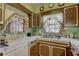 Charming kitchen with wood cabinets, laminate countertops, and mint green backsplash at 3104 W Powhatan Ave, Tampa, FL 33614