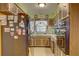 Kitchen featuring wood cabinets, laminate counters, a refrigerator and a window at 3104 W Powhatan Ave, Tampa, FL 33614