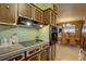 Open kitchen design offering wood cabinets, laminate countertops and modern appliances at 3104 W Powhatan Ave, Tampa, FL 33614