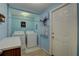 Laundry room equipped with washer, dryer, and storage solutions maximizes efficiency at 3104 W Powhatan Ave, Tampa, FL 33614