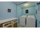 Laundry room equipped with modern appliances and efficient storage options maximizes functionality at 3104 W Powhatan Ave, Tampa, FL 33614