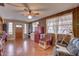 Cozy living room featuring wood-look tile flooring, a ceiling fan, and ample natural light at 3104 W Powhatan Ave, Tampa, FL 33614