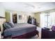 This spacious bedroom features neutral carpeting, a ceiling fan, and an attached closet for ample storage at 3139 W Varn Ave, Tampa, FL 33611