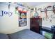 Bedroom featuring a cozy bed, a baseball themed wall design, and a window for natural light at 3139 W Varn Ave, Tampa, FL 33611