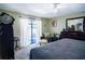 The primary bedroom includes sliding glass doors and an area rug at 3139 W Varn Ave, Tampa, FL 33611