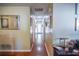 Inviting hallway with hardwood floors leading to a bright white door and neutral colored walls at 3139 W Varn Ave, Tampa, FL 33611
