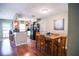 Eat-in kitchen featuring warm wood cabinets, black appliances and a dining area with seating at 3139 W Varn Ave, Tampa, FL 33611
