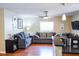 Bright living room featuring couches, natural light, and a ceiling fan at 3139 W Varn Ave, Tampa, FL 33611