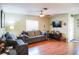 Well-lit living room with comfortable seating, a ceiling fan, and a mounted television at 3139 W Varn Ave, Tampa, FL 33611