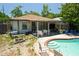Outdoor pool featuring a patio with white furniture and a grill at 3139 W Varn Ave, Tampa, FL 33611