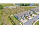 Aerial view showcasing the community's townhomes, streetscapes, and common area with a pond at 3228 Bryant Park Dr, New Port Richey, FL 34655