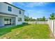Well-maintained backyard surrounded by a tall, white fence at 3228 Bryant Park Dr, New Port Richey, FL 34655