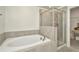 Bright bathroom featuring a soaking tub and glass walk-in shower at 3228 Bryant Park Dr, New Port Richey, FL 34655