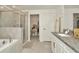 Elegant bathroom with walk-in shower, soaking tub, and granite counters at 3228 Bryant Park Dr, New Port Richey, FL 34655