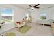Bedroom featuring a desk, seating area and two bright windows at 3228 Bryant Park Dr, New Port Richey, FL 34655