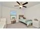 Charming bedroom featuring a ceiling fan, window, and ample space at 3228 Bryant Park Dr, New Port Richey, FL 34655