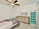 Comfortable bedroom with ceiling fan, window, and neutral decor at 3228 Bryant Park Dr, New Port Richey, FL 34655