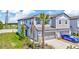 Well-maintained townhome with a two-car garage, blue car, and nicely landscaped front yard at 3228 Bryant Park Dr, New Port Richey, FL 34655