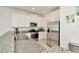 Modern kitchen features granite countertops, stainless steel appliances, and ample cabinet space at 3228 Bryant Park Dr, New Port Richey, FL 34655