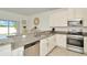 Stylish kitchen with granite countertops, stainless steel appliances, and breakfast bar with backyard views at 3228 Bryant Park Dr, New Port Richey, FL 34655