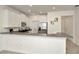 Eat-in kitchen featuring white cabinetry, stainless steel appliances, granite countertops, and breakfast bar at 3228 Bryant Park Dr, New Port Richey, FL 34655