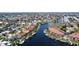 Aerial view showcases community homes and condos on canals with boat docks and lush greenery in the neighborhood at 3334 Purple Martin Dr # 212, Punta Gorda, FL 33950