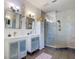 Bathroom featuring double sinks, modern fixtures, and a glass enclosed shower at 3334 Purple Martin Dr # 212, Punta Gorda, FL 33950
