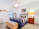 Bright bedroom features a metal frame bed, ceiling fan, and rustic decor to create a warm, inviting space at 3334 Purple Martin Dr # 212, Punta Gorda, FL 33950