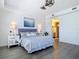 Bright bedroom with a king bed and an ensuite bathroom with wood-look floors at 3334 Purple Martin Dr # 212, Punta Gorda, FL 33950