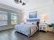 Bedroom featuring abundant natural light, a king bed, and wood-look flooring at 3334 Purple Martin Dr # 212, Punta Gorda, FL 33950