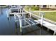 View of boat lift and dock with waterfront access in a well-maintained community setting at 3334 Purple Martin Dr # 212, Punta Gorda, FL 33950