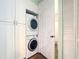 Practical laundry area showcases stacked washer and dryer units, with ample storage cabinets for convenience and organization at 3334 Purple Martin Dr # 212, Punta Gorda, FL 33950