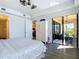 Main bedroom features white Armoire, access to porch, and plenty of natural light at 3334 Purple Martin Dr # 212, Punta Gorda, FL 33950