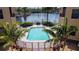 Community pool featuring a beautiful waterfront view, a grill, and ample seating at 3334 Purple Martin Dr # 212, Punta Gorda, FL 33950