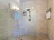 Close-up of a glass-enclosed shower with neutral tiling and a built-in bench at 3334 Purple Martin Dr # 212, Punta Gorda, FL 33950