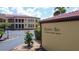 Grand Bay signage at 3334 Purple Martin Drive with manicured landscaping and a partial view of the building at 3334 Purple Martin Dr # 212, Punta Gorda, FL 33950
