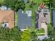 Bird's-eye view of a beautiful backyard with a uniquely shaped swimming pool and well-manicured landscaping at 3909 Valrico Grove Dr, Valrico, FL 33594