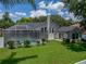 Backyard view features a screened-in pool and a well-maintained lawn at 3909 Valrico Grove Dr, Valrico, FL 33594
