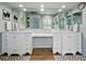 Spacious bathroom featuring dual vanities with white cabinetry, a large mirror, and a separate shower area at 3909 Valrico Grove Dr, Valrico, FL 33594