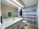 Bright bathroom features a white vanity, decorative boat shelf and a blue patterned shower curtain at 3909 Valrico Grove Dr, Valrico, FL 33594