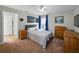 Bedroom showcasing a comfortable bed, classic wooden dressers, and walls adorned with captivating wall art at 3909 Valrico Grove Dr, Valrico, FL 33594