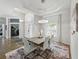 Elegant dining area with coffered ceilings, modern lighting, and views of the foyer at 3909 Valrico Grove Dr, Valrico, FL 33594