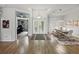 Bright, expansive foyer with double front doors, wood-look tile flooring, and views into the dining room at 3909 Valrico Grove Dr, Valrico, FL 33594