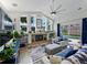 Bright living room with vaulted ceilings, fireplace, large windows and glass doors leading to the outdoor pool area at 3909 Valrico Grove Dr, Valrico, FL 33594