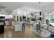 Bright open-concept area with kitchen, dining, and living spaces featuring a fireplace and pool views at 3909 Valrico Grove Dr, Valrico, FL 33594