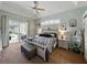 Airy bedroom featuring neutral walls, a ceiling fan, and sliding glass doors offering access to the outdoor living space at 3909 Valrico Grove Dr, Valrico, FL 33594